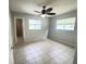 Spacious bedroom with ceiling fan, neutral walls, tile flooring and natural light at 3526 Southern W Pkwy, Bradenton, FL 34205