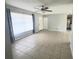 Bright living room featuring tile floors, large window, and ceiling fan at 3526 Southern W Pkwy, Bradenton, FL 34205