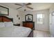 Bedroom with wood-look flooring, ceiling fan, and dresser with mirror at 3539 59Th W Ave # 3539, Bradenton, FL 34210