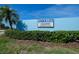 Entrance sign for Mirror Lake Condominiums, a deed-restricted community with lush landscaping at 3539 59Th W Ave # 3539, Bradenton, FL 34210