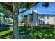 Exterior view of the home with a tree in the foreground and blue skies above at 3539 59Th W Ave # 3539, Bradenton, FL 34210