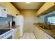 Bright kitchen with white cabinets, modern appliances, and neutral granite countertops at 3539 59Th W Ave # 3539, Bradenton, FL 34210