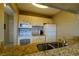 Efficient kitchen with granite countertops and modern appliances, including microwave and range at 3539 59Th W Ave # 3539, Bradenton, FL 34210