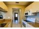Galley kitchen featuring modern appliances and a view into the other rooms at 3539 59Th W Ave # 3539, Bradenton, FL 34210