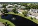 Scenic aerial view of Mirror Lake Condominiums with a tranquil pond and water fountain at 3539 59Th W Ave # 3539, Bradenton, FL 34210