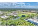 Aerial view showcasing a baseball stadium with green fields, buildings and a tranquil pond at 401 N Jefferson Ave, Sarasota, FL 34237