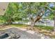 A large tree graces the backyard, adjacent to a brick patio and white fence, promising outdoor enjoyment at 401 N Jefferson Ave, Sarasota, FL 34237