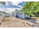 Charming backyard with a brick patio, gas grill, privacy fence, and mature trees for outdoor living at 401 N Jefferson Ave, Sarasota, FL 34237