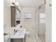 Modern bathroom with a glass door shower, gray vanity with sink, and neutral color scheme at 401 N Jefferson Ave, Sarasota, FL 34237