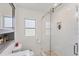 Clean bathroom with a glass shower door, vanity with sink, and window that provides natural light at 401 N Jefferson Ave, Sarasota, FL 34237