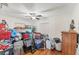 A cluttered bedroom with hardwood floors and a ceiling fan provides a glimpse of a customizable space at 401 N Jefferson Ave, Sarasota, FL 34237