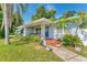 Inviting covered front porch with seating, plants, and a blue door with wreath detail at 401 N Jefferson Ave, Sarasota, FL 34237