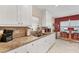 Modern kitchen featuring white cabinets, granite countertops, and a cozy breakfast nook at 401 N Jefferson Ave, Sarasota, FL 34237