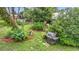 Landscaped backyard with a grill and lush greenery, perfect for outdoor dining at 408 67Th W Ave, Bradenton, FL 34207