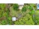 Aerial view showcases the backyard's lush gardens, outdoor seating, and well-maintained lawn at 408 67Th W Ave, Bradenton, FL 34207
