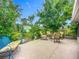 Backyard patio with seating area, perfect for outdoor entertaining amidst lush greenery at 408 67Th W Ave, Bradenton, FL 34207