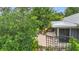 Outdoor patio with lush landscaping, seating arrangement, and tranquil setting at 408 67Th W Ave, Bradenton, FL 34207