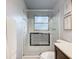 Bathroom with a glass-enclosed shower showcasing decorative tiles, complemented by a clean, white interior at 408 67Th W Ave, Bradenton, FL 34207