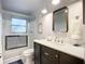 Modern bathroom featuring a glass-enclosed shower with decorative tiles and a stylish vanity with a white countertop at 408 67Th W Ave, Bradenton, FL 34207
