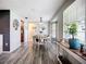Inviting dining room featuring wood floors, bay window, and a stylish light fixture above the round dining table at 408 67Th W Ave, Bradenton, FL 34207