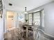 Bright dining room boasting a large window and a modern light fixture over the wooden dining table at 408 67Th W Ave, Bradenton, FL 34207