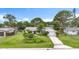 Charming single-story home with an attached garage, complemented by a lush, landscaped front yard and a cozy walkway to the front door at 408 67Th W Ave, Bradenton, FL 34207