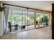 Enclosed Florida room with tile floors and multiple sliding glass doors to the backyard at 408 67Th W Ave, Bradenton, FL 34207