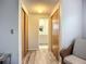 Hallway with closets leading to a bathroom with dual sinks at 408 67Th W Ave, Bradenton, FL 34207