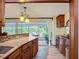 Well-lit kitchen with wood cabinets and countertops, plus a sunroom view at 408 67Th W Ave, Bradenton, FL 34207
