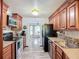 Kitchen featuring stainless steel appliances, wood cabinets, and tile backsplash at 408 67Th W Ave, Bradenton, FL 34207