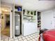 Well-organized laundry area with washer, dryer, water heater, and storage shelves at 408 67Th W Ave, Bradenton, FL 34207