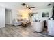 Bright living room with an open layout offers a glimpse of the lanai, plus attractive furnishings and stylish, wood-look flooring at 408 67Th W Ave, Bradenton, FL 34207