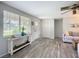 Welcoming living room features natural light, wood-look floors, and a view of the entry door, creating a bright and airy atmosphere at 408 67Th W Ave, Bradenton, FL 34207