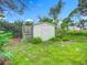 Outdoor shed on a grassy lawn, providing extra storage space with mature landscaping at 408 67Th W Ave, Bradenton, FL 34207