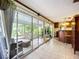 Bright sunroom leading to a bar area and furnished outdoor patio at 408 67Th W Ave, Bradenton, FL 34207