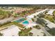 Overhead view of community amenities including pool and tennis courts surrounded by beautiful trees at 4107 Brittany Ln # 18, Sarasota, FL 34233