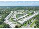 An aerial view of the neighborhood showcasing homes surrounding a picturesque pond at 4107 Brittany Ln # 18, Sarasota, FL 34233