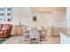 Bright dining room with tile floors, white walls, leather couches, wine rack, and dining table at 4107 Brittany Ln # 18, Sarasota, FL 34233
