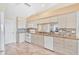 Bright kitchen with white appliances, cabinets, tile backsplash and marble countertops at 4107 Brittany Ln # 18, Sarasota, FL 34233