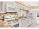 Stylish kitchen featuring custom cabinetry, granite counters, and modern appliances at 4107 Brittany Ln # 18, Sarasota, FL 34233