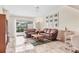 Bright living room with tile floors, white walls, leather couches, and dining area at 4107 Brittany Ln # 18, Sarasota, FL 34233