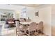 Bright living room with tile floors, white walls, leather couches, and dining area at 4107 Brittany Ln # 18, Sarasota, FL 34233