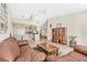 Bright living room featuring a cozy brown leather sofa, and an open view to the kitchen at 4107 Brittany Ln # 18, Sarasota, FL 34233