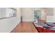 Light filled living area featuring parquet floors and a view into other living and dining areas at 4107 Brittany Ln # 18, Sarasota, FL 34233