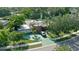 Expansive aerial view of a home with a brick accent, mature trees, and green driveway at 4158 Prudence Dr, Sarasota, FL 34235