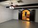 Unique basement space with exposed beams, arched doorway, and neutral colored walls at 4158 Prudence Dr, Sarasota, FL 34235