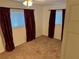 Cozy bedroom with neutral carpet and red curtains at 4158 Prudence Dr, Sarasota, FL 34235