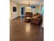 Cozy living room featuring hardwood floors, a leather sofa set, and elegant lighting at 4158 Prudence Dr, Sarasota, FL 34235