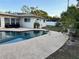 Inviting pool area with clear blue water, a concrete deck, and lush greenery surrounding at 4158 Prudence Dr, Sarasota, FL 34235