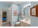 Bathroom with blue walls, nautical decor, and access to the outdoor pool area through a glass door at 4410 67Th Avenue E Cir, Sarasota, FL 34243